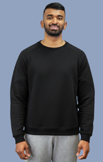 Salt Leisure Wear resilient bamboo men's crew neck sweatshirt with arm pockets for easy access, shown in a relaxed fit on a model.